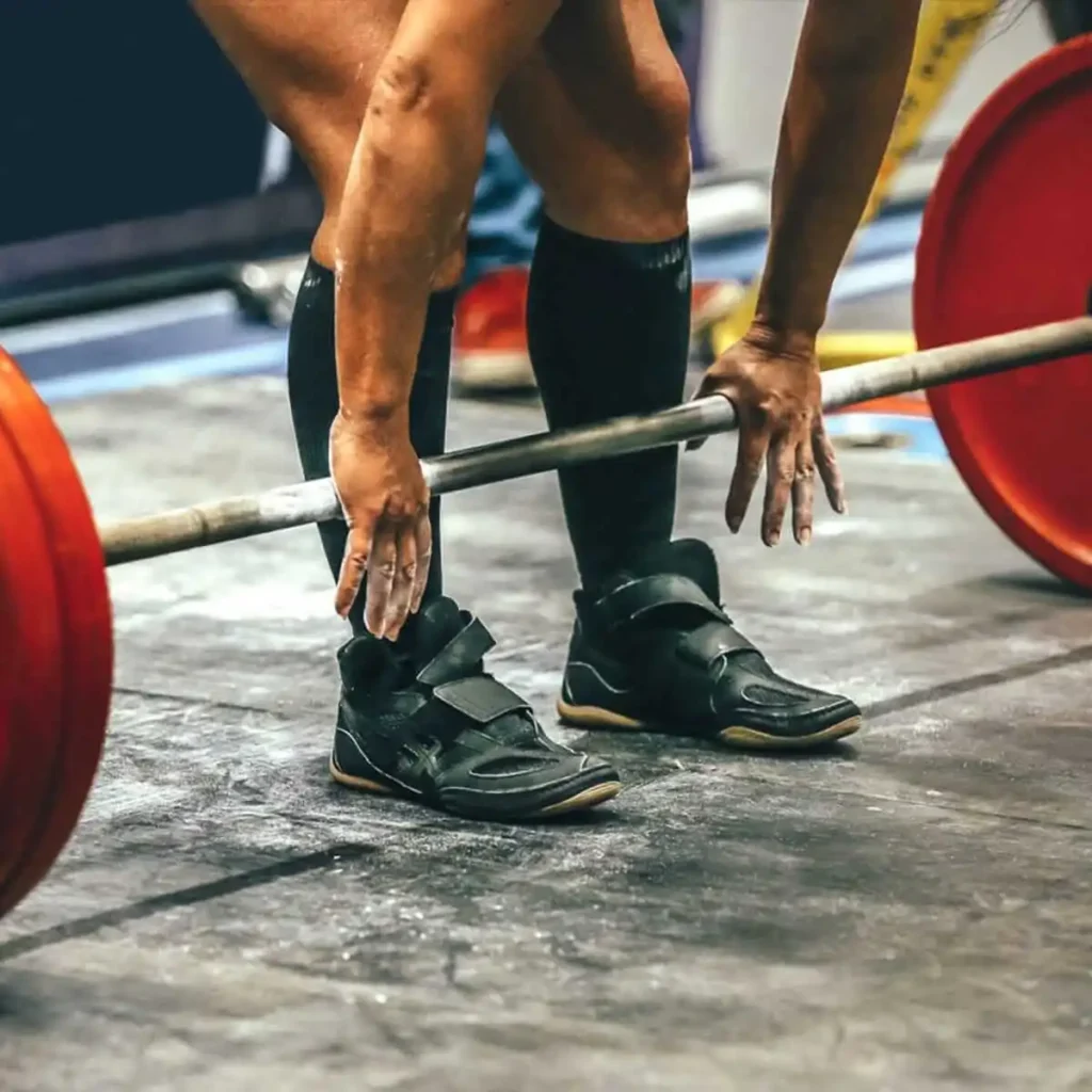 people using liquid chalk to when lifting weights 